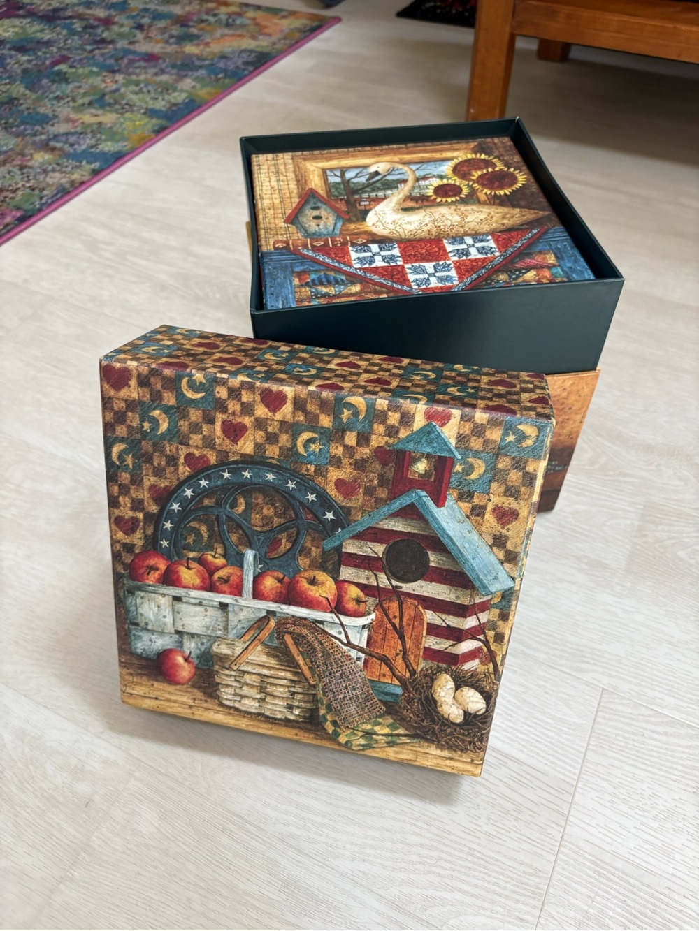 Decorative set of seven nesting boxes with a country folk art aesthetic.